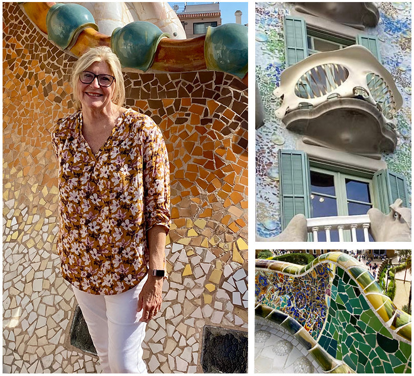 Image of an Australian woman wearing an eco-conscious, 3/4 sleeve, shirt in a floral print as part of her ultimate capsule travel wardrobe. She is wearing L&Fs lightweight holiday clothing in Barcelona next to Gaudi buildings.  