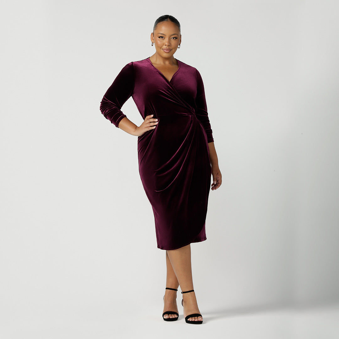 A good dress for evening and cocktail wear, this long sleeve wrap dress in wine velour is owrn by a size 18, plus size woman to show occasion wear investment pieces.