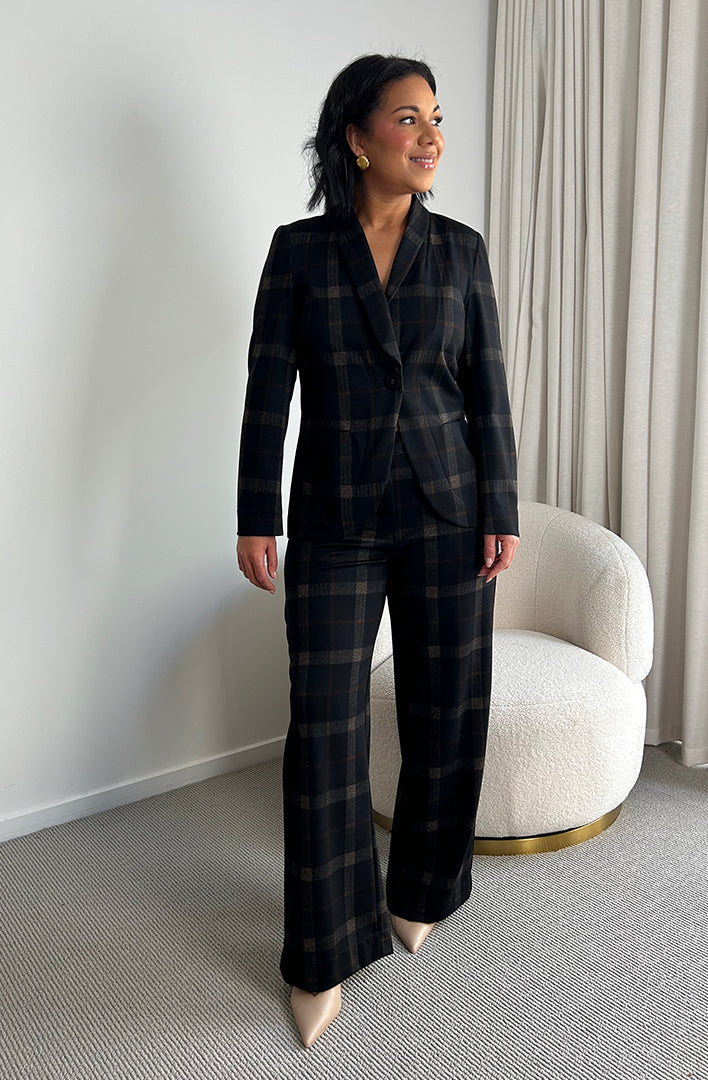 Showing a work wear outfit for professional women, a size 10 woman wears a coco plaid blazer and wide leg pants. Both blazer and pants for women are made in Australia in sizes 8-24 by women's clothing brand, Leina + Fleur. 