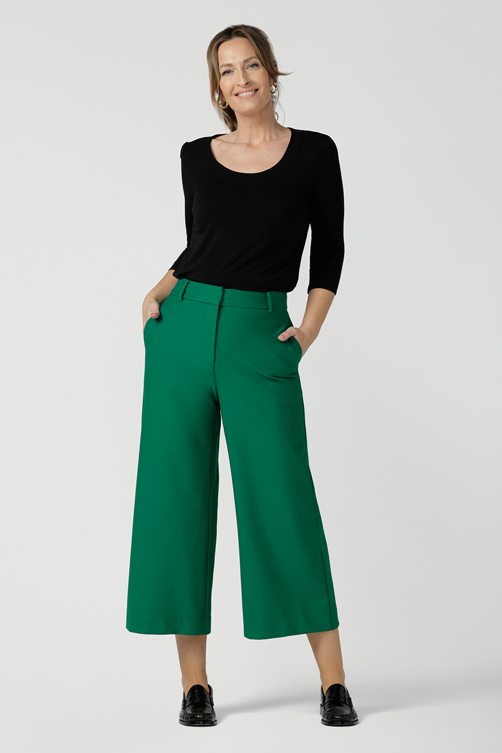 An elegant top for work and casual wear, this scoop neck, 3/4 sleeve top in black bamboo jersey is made in Australia by Australian and New Zealand women's clothing brand, Leina & Fleur. Worn with green, wide leg tailored work pants, shop this comfortable work top online in petite, mid size and plus sizes.