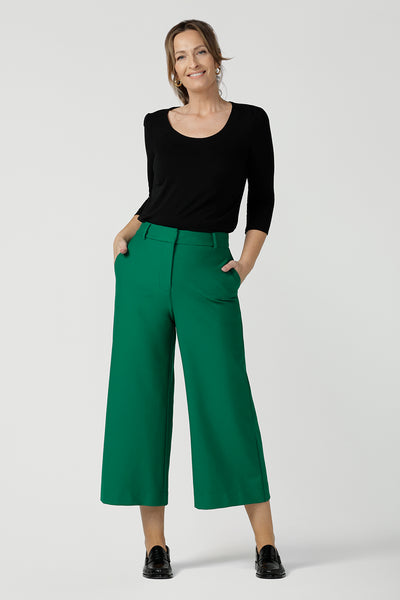 An elegant top for work and casual wear, this scoop neck, 3/4 sleeve top in black bamboo jersey is made in Australia by Australian and New Zealand women's clothing brand, Leina & Fleur. Worn with green, wide leg tailored work pants, shop this comfortable work top online in petite, mid size and plus sizes.