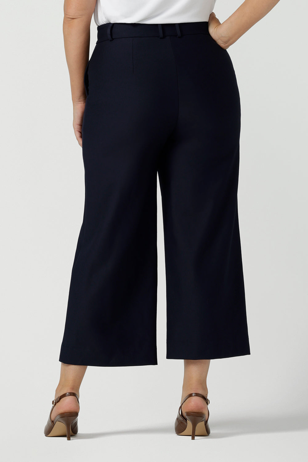 Back view of the Yael Pant in Navy Ponte. Tailored high waist pants with pockets and front zip. Cropped culotte length and styled back with white bamboo top. Made in Australia for women size 8 - 24.