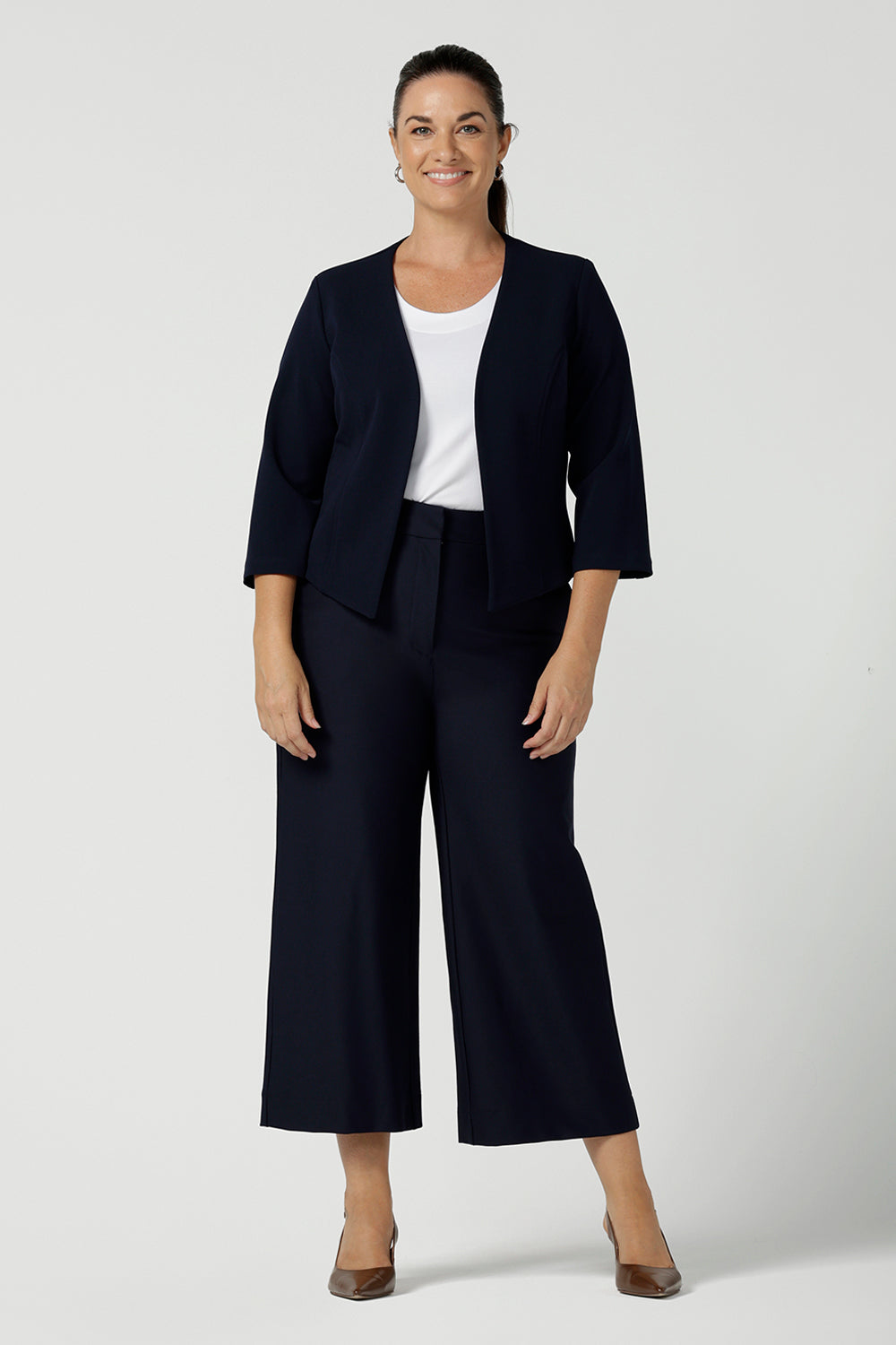 Yael Pant in Navy Ponte. Tailored high waist pants with pockets and front zip. Cropped culotte length and styled back with white bamboo top. Made in Australia for women size 8 - 24. Styled back with Navy blazer jacekt.