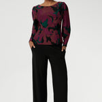 The Fuchsia Maya print is on a soft touch jersey fabric with print details in deep fuchsia, green, terracotta and black. The fabric has soft stretch. Size 10 model wears her long sleeved top with black workwear pants and loafers. Available in sizes 8-24.