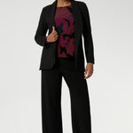 Zara is a modern-cut top with bellow sleeves and a subtle shape through the body—an effortless choice for transitioning from work to weekend. Pairs perfectly with our soft suiting collection. Size 10 model wears her printed workwear top with black easy care blazer and matching black pants.