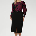 The Fuchsia Maya print is on a soft touch jersey fabric with print details in deep fuchsia, green, terracotta and black. The fabric has soft stretch. Plus size model wears her long sleeved top tucked into black workwear skirt. Available in sizes 8-24.