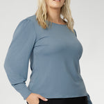 The Zara knit top, a refined yet relaxed essential designed for cool-weather layering. With its modern silhouette and graceful bellow sleeves, this piece delivers understated elegance and all-day comfort. The boat neckline frames the collarbone with subtle sophistication, while tailored bust darts and a close-to-body shape enhance the fit without feeling restrictive.