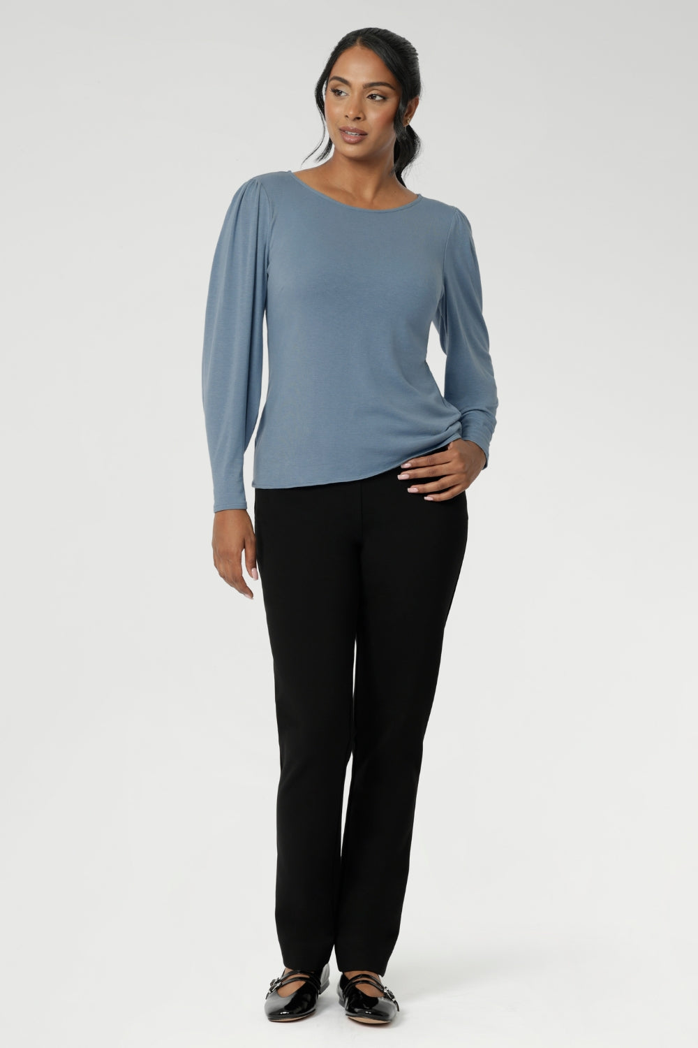 A straight hemline at the front keeps the look streamlined, while the longer, curved hem at the back offers extra coverage and an elevated finish. Looks wonderful tucked or untucked into pants or skirts. Size 10 women wears Zara Knit Top in Sky with exact Black Paxton Pant.