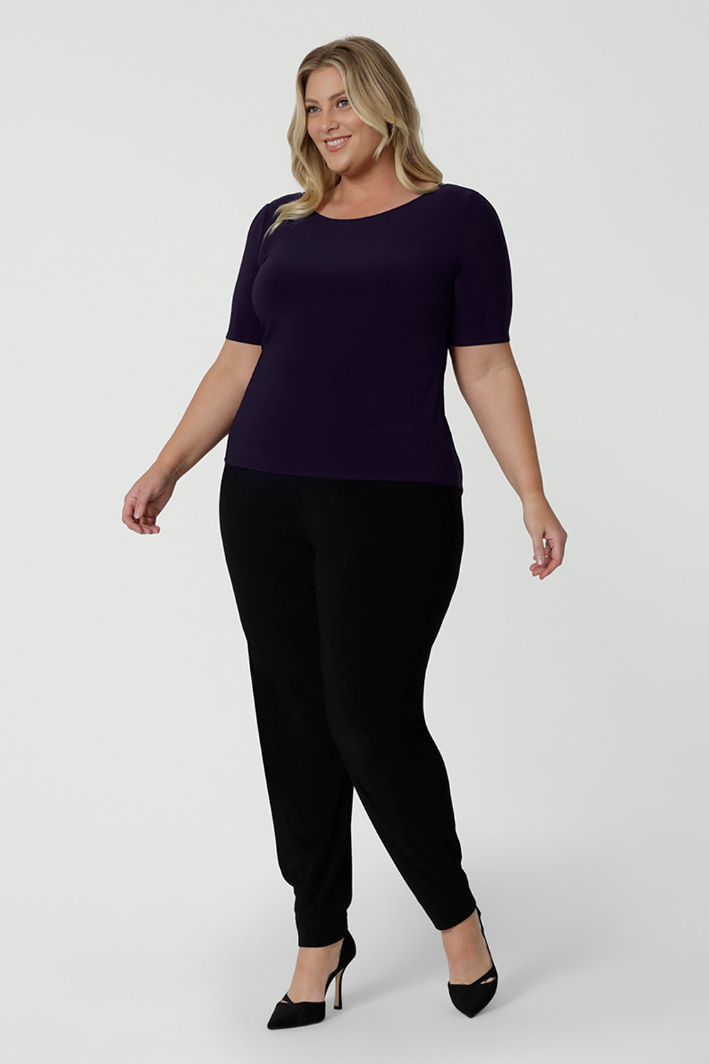 A good work top for plus size women, this is a boat neck top in amethyst jersey is worn with black, tapered leg pants. Full of stretch this comfortable top is easy to wear and easy-care. Made in Australia by Australian and New Zealand women's clothes brand, Leina & Fleur, shop tops for petite to plus size women online.