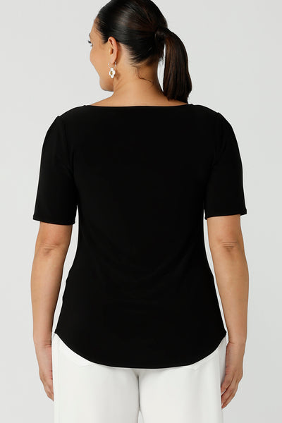 Back view of a curvy size 12 woman wears a jersey Ziggy top with a round neckline and elbow-length sleeve and curved hemline. The perfect work top for comfortable corporate wear. Made in Australia for Australian fashion label Leina & Fleur sizes 8 -24.