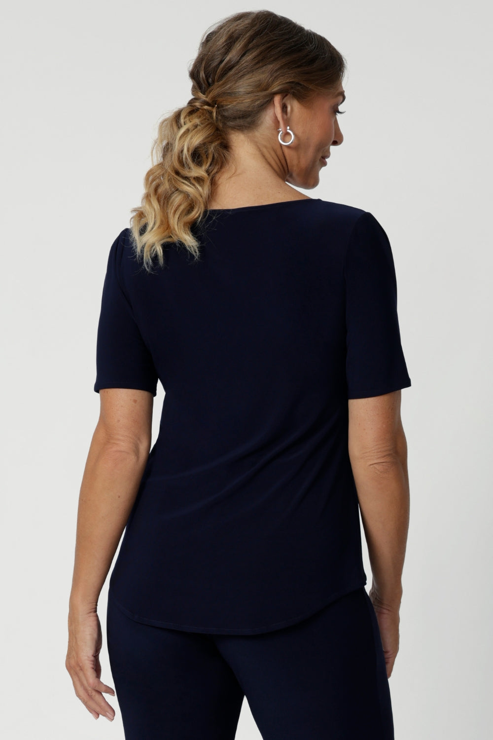 Back view image of navy top featuring elbow sleeves, straight neckline and straight hem. Can be easily paired with printed pants and heels for an elevated look or with sneakers for a casual look. Available in size 8-24.