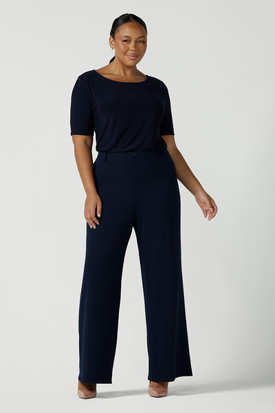 Size 10 model wears the Navy wide leg pant with navy scuba crepe. High waisted and tailored with belt loops. Stylish and corporate workwear for women size 8 - 24.. Made in Australia. 