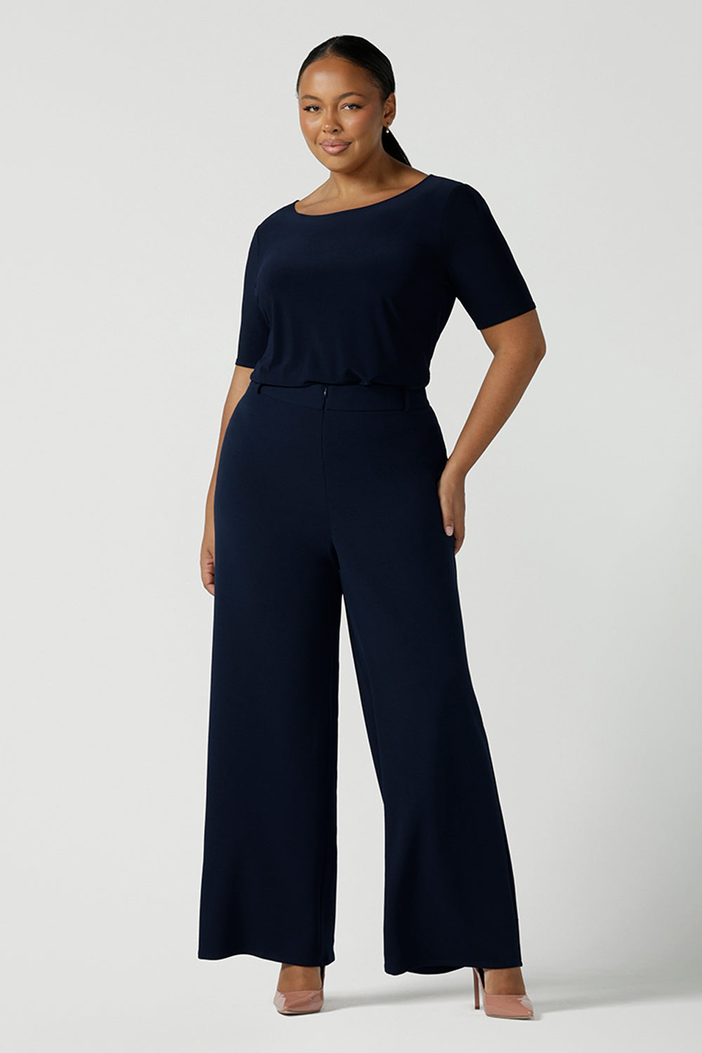 Size 10 model wears the Navy wide leg pant with navy scuba crepe. High waisted and tailored with belt loops. Stylish and corporate workwear for women size 8 - 24.. Made in Australia.