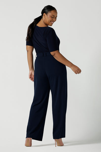 Back view of a size 10 model wears the Navy wide leg pant with navy scuba crepe. High waisted and tailored with belt loops. Stylish and corporate workwear for women size 8 - 24.. Made in Australia.