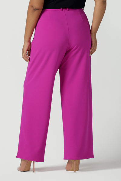 Back view of a size 16 Woman wears the Drew Pant in Fuchsia. A high waist tailored pant with matching suit blazer. Made in Australia for women size 8 - 24.