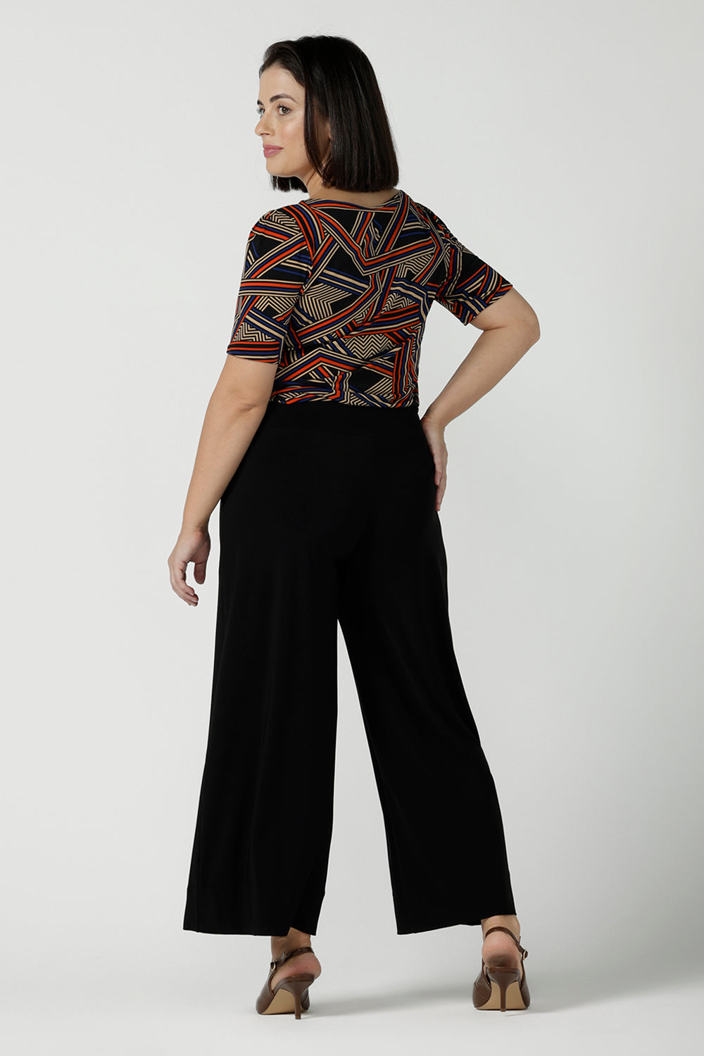 Back view of a size 10 woman wears the Ziggy Top in Trixe, a jersey boat neckline top and short sleeves. Conservative boat neckline and softly curved hem. Easy care jersey and size inclusive for petite to plus size. Made in Australia for women size 8 - 24.