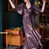 A size 10 woman wears a glamorous wrap dress for cocktail wear. Made in Australia wit pink foil mikado fabric with detailed design and flutter with with tears. Low neckline and flattering for all shapes petite to plus size ladies clothing. Made in Australia for women size 8 - 24. 