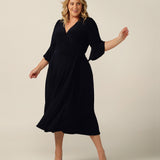 Navy blue wrap dress with fluted sleeves for plus size women.