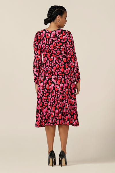 back view of the empire line Alyssa Dress in Wild Poppy floral print. Designed for workwear or occasionwear, this jersey dress has a V neck, knee length skirt and long sleeves with ruched cuffs. Made in Australia by Gold Coast women's fashion label, L&F