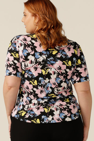 Back view of a size 18 plus size woman wears a printed jersey top with short sleeves and square scoop neckline. A good top for full busts, the Berni Top has a structured bust. This top is available to shop online in sizes 8 to size 24.