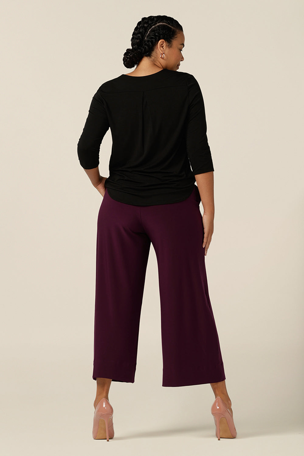 Back view of a wide leg pant in Mulberry jersey. These wide leg trousers are cropped in length and feature side front pockets and a deep waistband.
