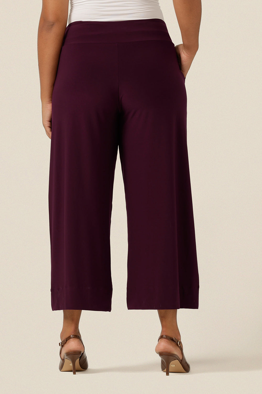 Back view of a wide leg pant in Mulberry jersey. These wide leg trousers are cropped in length and feature side front pockets and a deep waistband.