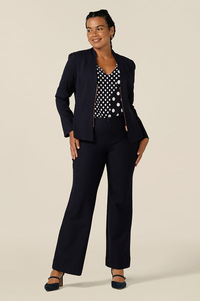 Australian-made, this workwear outfit features navy, flared-leg pants, navy and white spot print top and soft tailoring jacket in navy.