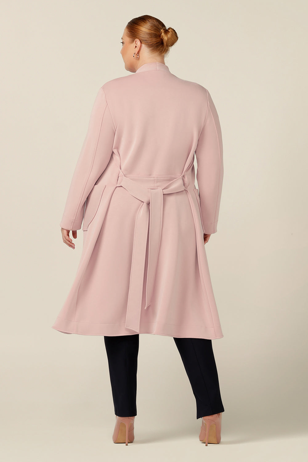Back view of Australia and New Zealand women's clothing label, L&Fs best lightweight coat for winter. In dusty pink Modal, this coat has stretch for comfortable wear over workwear and corporate suiting, making it a great coat for travelling that work day commute. 