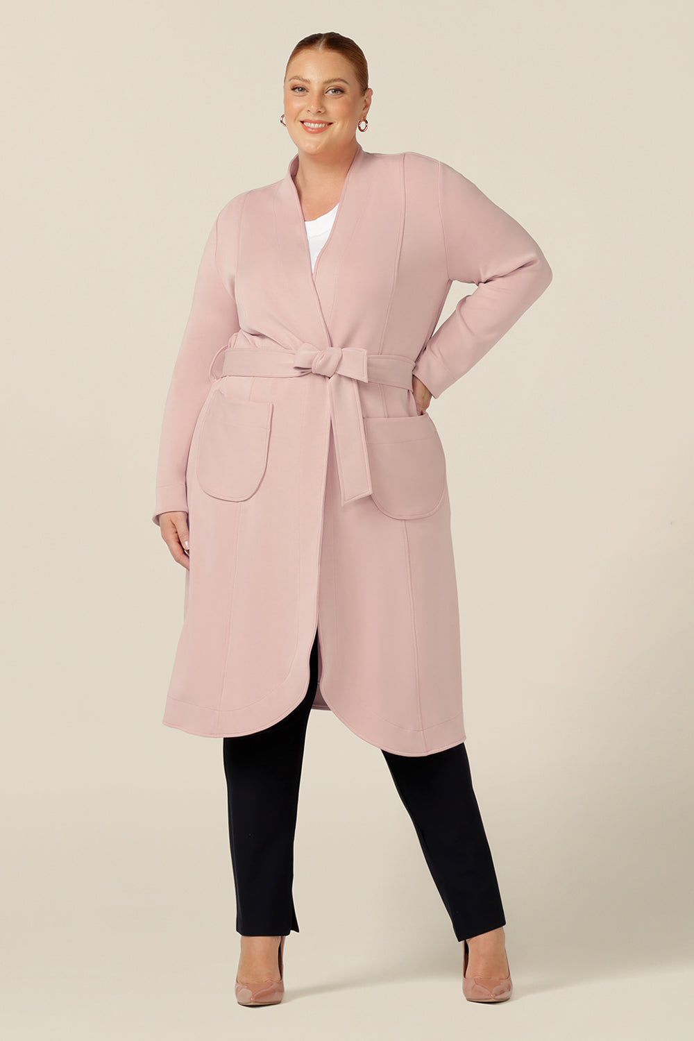 wrap up for winter in this stylish soft tailoring trenchcoat by Australia and New Zealand women's clothing label, L&F. Featuring a grown on collar, long sleeves, midi-length hemline and fabric belt tie, this luxurious feel coat in dusty pink modal wears well over corporate suiting and workwear layers .
