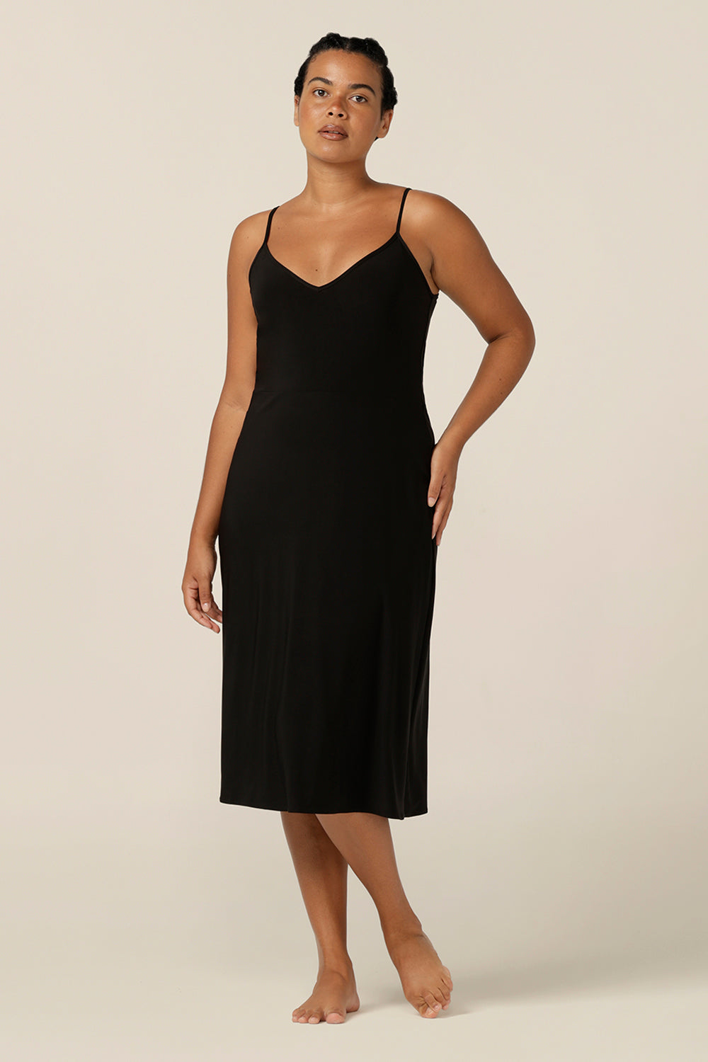 size 12 woman wears a midi-length, reversible slip in black, slinky jersey fabric. 