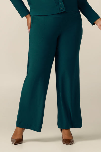 A close up of an Australian-made wide leg, full length jersey trouser in petrol green. By Australian and New Zealand fashion brand, L&F these straight-cut work pants promise to be a comfortable corporate trouser for sizes 8 to size 24. Worn with a matching petrol green soft jacket for a soft suiting workwear outfit.