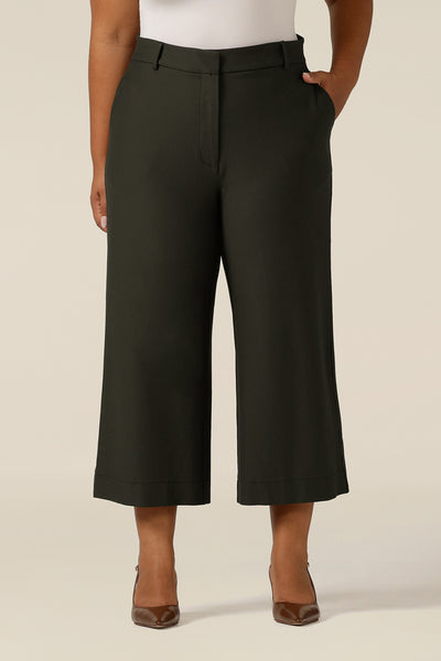 image shows tailored work wear pants with cropped, wide legs and side pockets in olive green ponte jersey